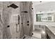 Detailed view of the marble shower with dual shower heads, featuring modern fixtures and tiling at 21 Grey Owl Ct, Las Vegas, NV 89135