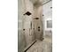 Modern shower with dual shower heads, elegant stone walls, and sleek fixtures for a luxurious spa experience at 21 Grey Owl Ct, Las Vegas, NV 89135