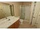 Well-lit bathroom featuring a glass enclosed shower and a sink with tiled countertop and wooden cabinet at 2110 Los Feliz St # 2052, Las Vegas, NV 89156