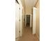 Hallway with neutral walls and carpet flooring connecting different areas of this cozy home at 2110 Los Feliz St # 2052, Las Vegas, NV 89156