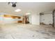 Spacious garage with overhead storage and workshop area at 2179 Bridlewood Dr, Las Vegas, NV 89119