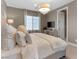 Primary bedroom with a plush bed and sitting area at 26 Olympia Outlook Dr, Las Vegas, NV 89141