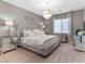 Primary bedroom with plush bed and sitting area at 26 Olympia Outlook Dr, Las Vegas, NV 89141