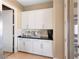 White cabinetry butlers pantry with granite countertops at 26 Olympia Outlook Dr, Las Vegas, NV 89141