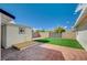 Landscaped backyard with artificial turf and storage shed at 2690 S Dandelion St, Pahrump, NV 89048