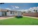 Artificial turf backyard with storage shed and patio at 2690 S Dandelion St, Pahrump, NV 89048