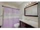 Clean bathroom with dark vanity and lavender shower curtain at 2690 S Dandelion St, Pahrump, NV 89048