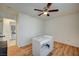 Spacious bedroom with ceiling fan, wood floor, and view of dining area at 2690 S Dandelion St, Pahrump, NV 89048