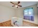 Bright bedroom with ceiling fan, wood flooring, and built-in storage at 2690 S Dandelion St, Pahrump, NV 89048