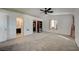 Large bedroom with carpet flooring, ceiling fan and access to en-suite bathroom at 2690 S Dandelion St, Pahrump, NV 89048