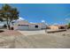 White single-story house with a two-car garage and landscaped yard at 2690 S Dandelion St, Pahrump, NV 89048