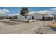 Front view of a remodeled home with a large driveway and a new fence at 2690 S Dandelion St, Pahrump, NV 89048