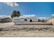Newly renovated single story home with a large driveway and desert landscaping at 2690 S Dandelion St, Pahrump, NV 89048