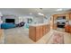 Open kitchen with island, wood cabinets, and granite countertops at 2690 S Dandelion St, Pahrump, NV 89048