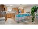 Kitchen with wood cabinets, granite counters, and a breakfast bar at 2690 S Dandelion St, Pahrump, NV 89048