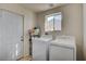 Laundry room with washer, dryer, and storage at 2690 S Dandelion St, Pahrump, NV 89048