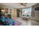 Bright living room with large window and ceiling fan at 2690 S Dandelion St, Pahrump, NV 89048