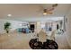 Bright living room features tile floors, a ceiling fan, and ample space for furniture at 2690 S Dandelion St, Pahrump, NV 89048