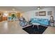 Spacious living room with open concept layout, sectional sofa and kitchen view at 2690 S Dandelion St, Pahrump, NV 89048