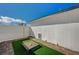 Small fenced patio with artificial turf and pet game at 2690 S Dandelion St, Pahrump, NV 89048