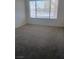 Bright bedroom featuring neutral carpet and a large window at 3055 Key Largo Dr # 203, Las Vegas, NV 89120