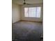Spacious bedroom with carpet and natural light from the large window at 3055 Key Largo Dr # 203, Las Vegas, NV 89120