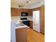 Well-lit kitchen with wooden cabinets, white countertops, and stainless steel sink at 3055 Key Largo Dr # 203, Las Vegas, NV 89120
