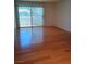 Bright living room featuring wood floors, large sliding glass door, and natural light at 3055 Key Largo Dr # 203, Las Vegas, NV 89120