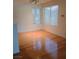 An empty living area showcasing hardwood floors and natural lighting from windows at 3055 Key Largo Dr # 203, Las Vegas, NV 89120