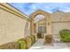 Arched entryway with walkway and well-manicured landscaping at 448 Wonderstone Dr, Las Vegas, NV 89107