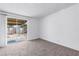 Spacious bedroom with neutral carpeting and sliding glass door to backyard at 4554 S Nellis Blvd, Las Vegas, NV 89121