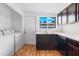 Kitchen with dark cabinets, stainless steel appliances, and laundry area at 4554 S Nellis Blvd, Las Vegas, NV 89121