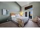Main bedroom with king bed, patio access, and high ceiling at 479 Via Ventana Dr, Mesquite, NV 89027