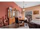 Bright dining room features a wood table and chairs, a china cabinet, and terracotta accents at 479 Via Ventana Dr, Mesquite, NV 89027