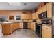 Modern kitchen with granite counters, stainless steel appliances, and light wood cabinets at 479 Via Ventana Dr, Mesquite, NV 89027