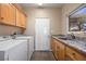 Laundry room with granite countertop, wood cabinets, and washer/dryer at 479 Via Ventana Dr, Mesquite, NV 89027
