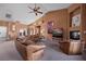 Spacious living room with vaulted ceiling, leather sofas, fireplace, and large TV at 479 Via Ventana Dr, Mesquite, NV 89027