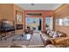 Spacious living room with leather sofas, fireplace, and golf course view at 479 Via Ventana Dr, Mesquite, NV 89027