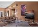 Living room with leather sofas, a large TV, and views to backyard at 479 Via Ventana Dr, Mesquite, NV 89027