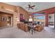 Living room with vaulted ceiling, leather couches, and access to a patio at 479 Via Ventana Dr, Mesquite, NV 89027