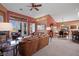 Open living and dining area with leather furniture, high ceilings, and access to patio at 479 Via Ventana Dr, Mesquite, NV 89027