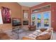 Living room with a fireplace, leather furniture, and access to the backyard at 479 Via Ventana Dr, Mesquite, NV 89027