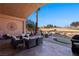 Covered patio with comfortable seating, fire pit, and golf course view at 479 Via Ventana Dr, Mesquite, NV 89027