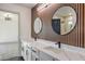 Contemporary bathroom with dual sinks, decorative wall, and black matte fixtures at 4871 Charlemagne Ave, Las Vegas, NV 89130