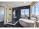 Modern bathroom features a soaking tub, glass enclosed shower, and natural light at 4871 Charlemagne Ave, Las Vegas, NV 89130