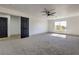 Spacious bedroom with plush carpet, ceiling fan, and views from a window at 4871 Charlemagne Ave, Las Vegas, NV 89130