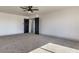 Open bedroom with plush carpet features a ceiling fan and access to other rooms at 4871 Charlemagne Ave, Las Vegas, NV 89130