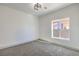 Clean bedroom with gray carpet and natural light from a side window at 4871 Charlemagne Ave, Las Vegas, NV 89130