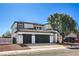 Two-story home featuring a multi-car driveway and an attractive landscaped yard with a beautiful tree at 4871 Charlemagne Ave, Las Vegas, NV 89130