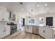 Well-lit kitchen showcasing white cabinetry, stainless steel appliances, and ample counter space at 4871 Charlemagne Ave, Las Vegas, NV 89130